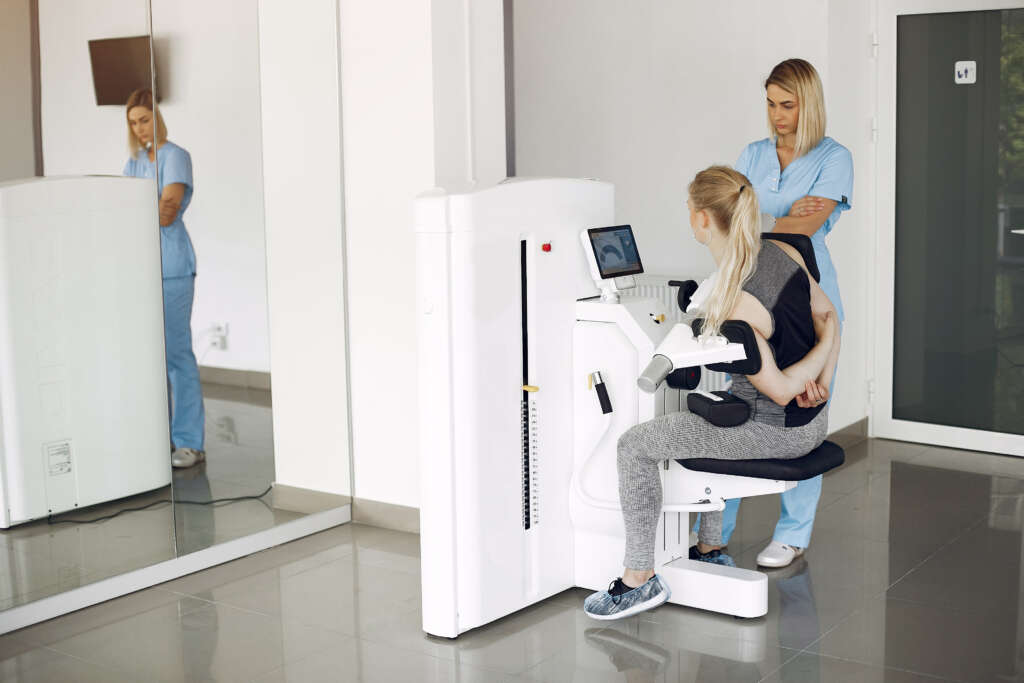 woman at physiotherapy making physical exercises with qualified